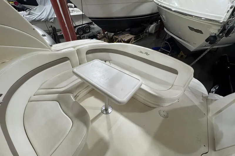 Slide: The Image of 2004 Sea Ray Sundancer 320 boat interior with seating and table in a storage area. - 37