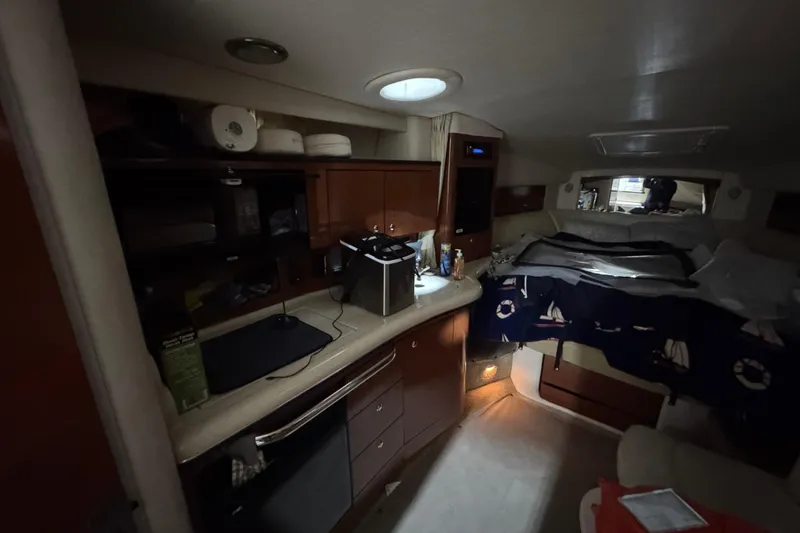 Slide: The Image of Interior of 2004 Sea Ray Sundancer 320 yacht with kitchenette and cozy sleeping area. - 49