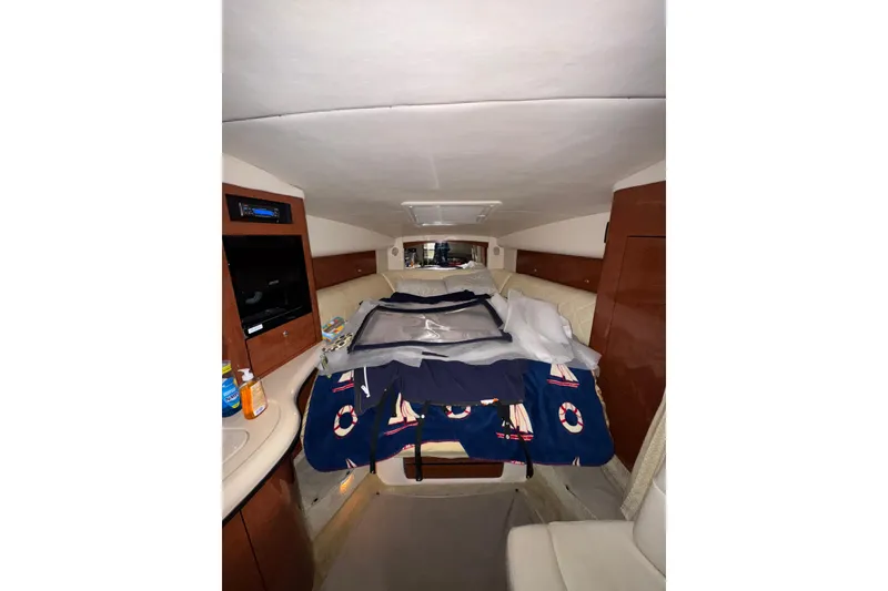Slide: The Image of Interior cabin of 2004 Sea Ray Sundancer 320 with bed and wooden cabinetry. - 50