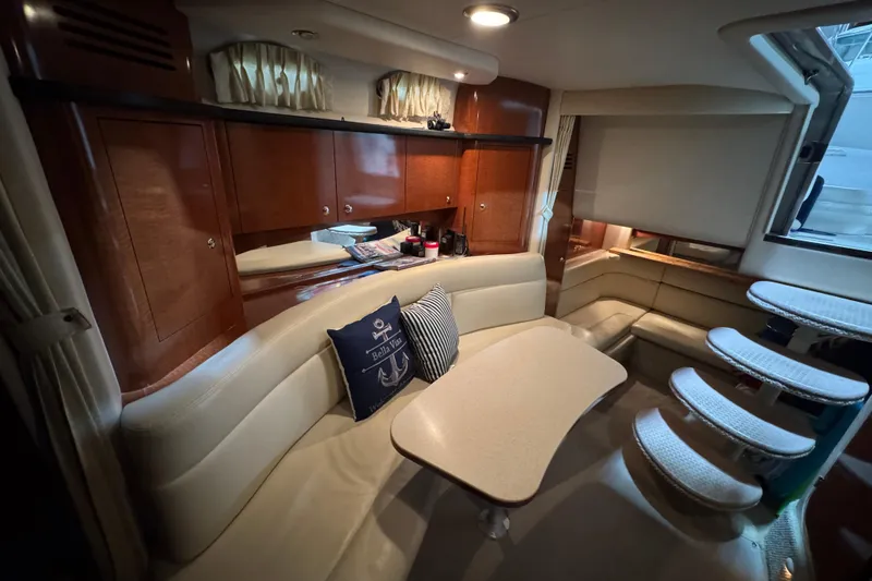 Slide: The Image of Interior of 2004 Sea Ray Sundancer 320 yacht with elegant seating and wooden cabinetry. - 54