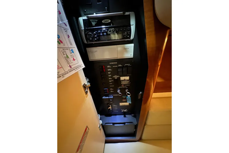 Slide: The Image of Electrical panel inside 2004 Sea Ray Sundancer 320 boat cabin, featuring control switches. - 55