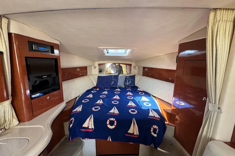 Slide: The Image of Luxurious cabin interior of 2004 Sea Ray Sundancer 320 yacht with nautical-themed bedding. - 57
