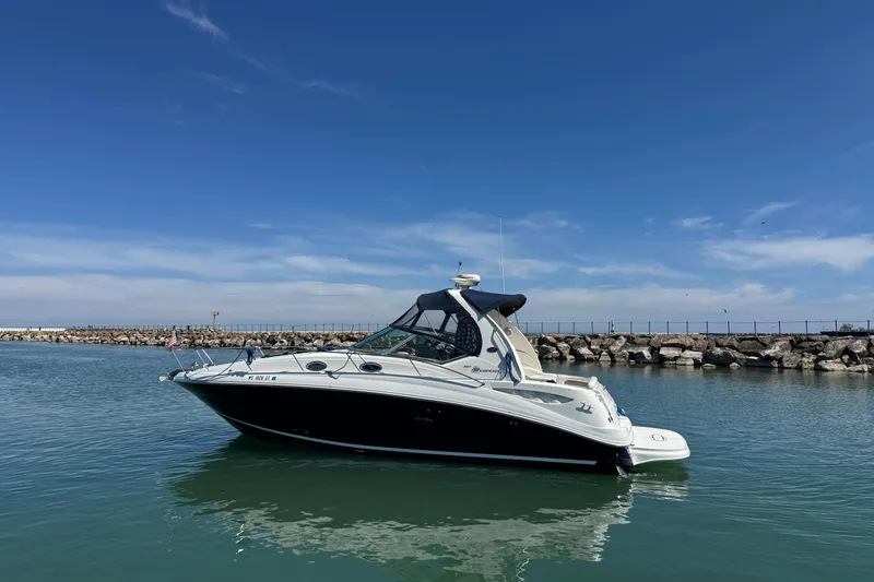 Slide: The Image of 2004 Sea Ray Sundancer 320 yacht on calm water with clear blue sky. - 6