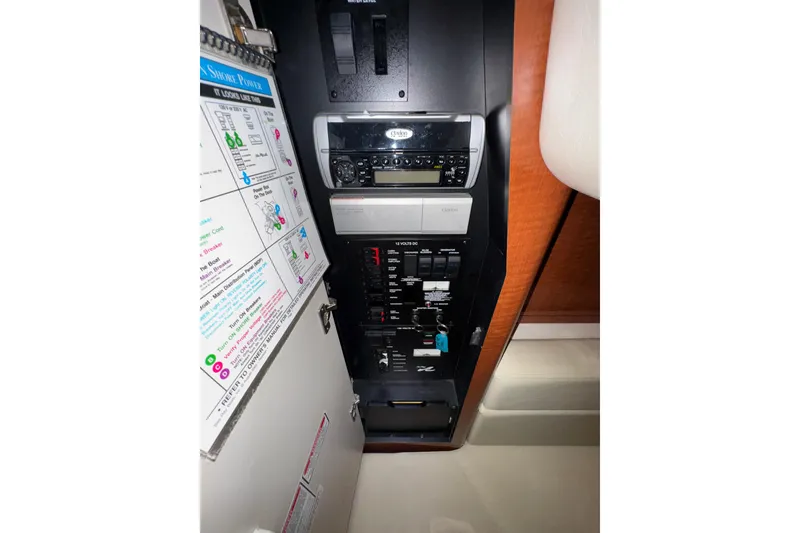 Slide: The Image of Control panel of a 2004 Sea Ray Sundancer 320 boat, featuring various switches and labels. - 63