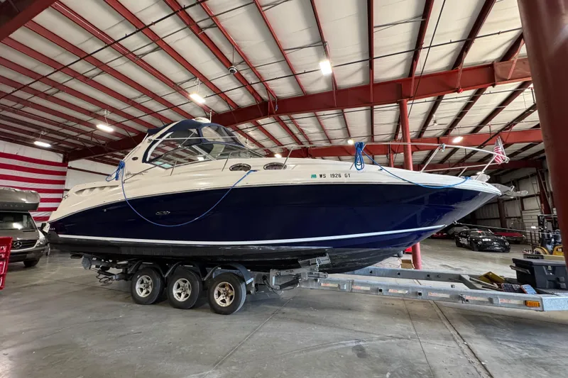 Slide: The Image of 2004 Sea Ray Sundancer 320 boat on trailer in indoor storage facility. - 65