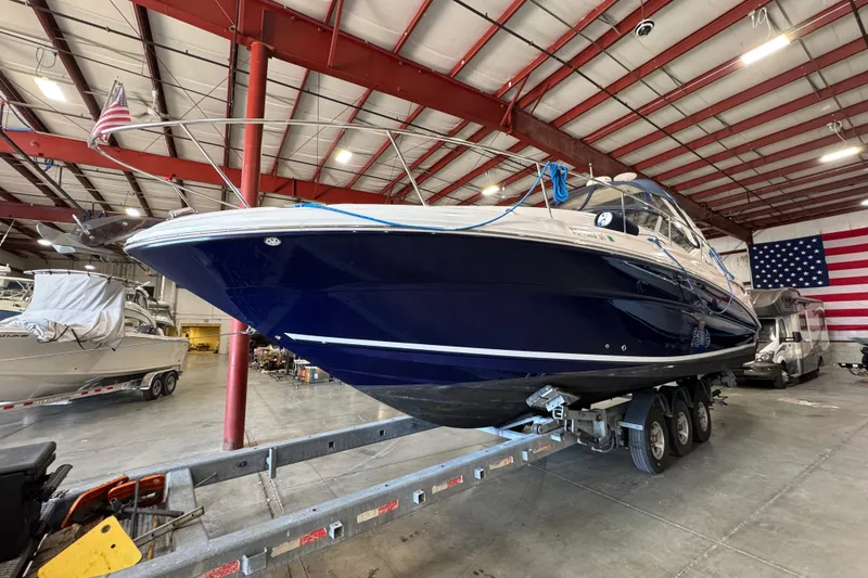 Slide: The Image of 2004 Sea Ray Sundancer 320 boat on trailer in warehouse with American flag. - 71