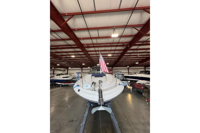 Slide: The Image of 2004 Sea Ray Sundancer 320 boat in indoor storage with American flag. - 74