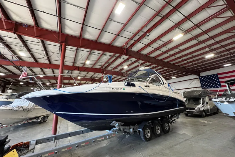 Slide: The Image of 2004 Sea Ray Sundancer 320 boat in indoor storage facility with American flag. - 76