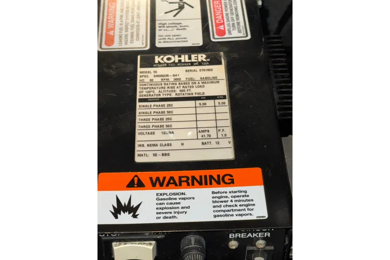 Slide: The Image of Kohler generator panel with warning labels on a 2004 Sea Ray Sundancer 320 boat. - 81