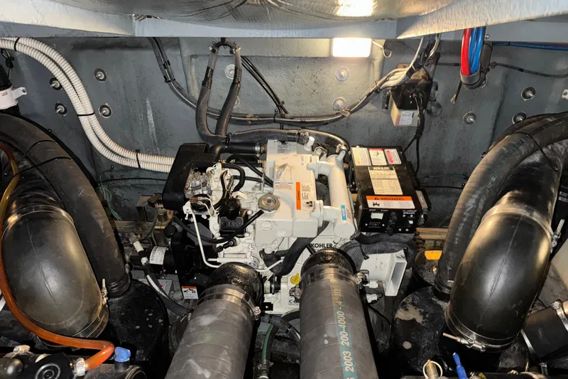 Slide: The Image of Engine compartment of a 2004 Sea Ray Sundancer 320 boat, featuring Kohler generator. - 83