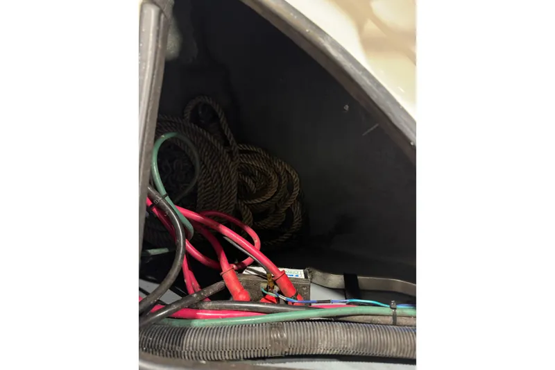 Slide: The Image of Electrical wiring and ropes inside a 2004 Sea Ray Sundancer 320 boat compartment. - 85