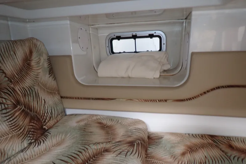 Slide: The Image of 2014 Pro-Line 32 Express cabin interior with patterned upholstery and small window. - 100