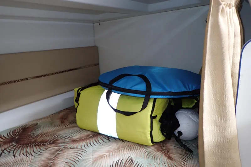 Slide: The Image of Interior cabin of 2014 Pro-Line 32 Express with bags on patterned bedding. - 102