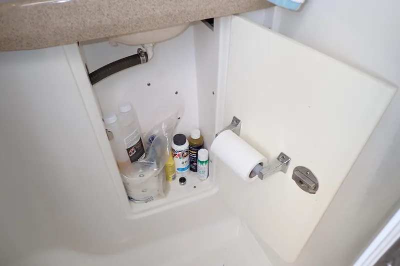 Slide: The Image of Storage cabinet in 2014 Pro-Line 32 Express boat with cleaning supplies and toilet paper. - 105