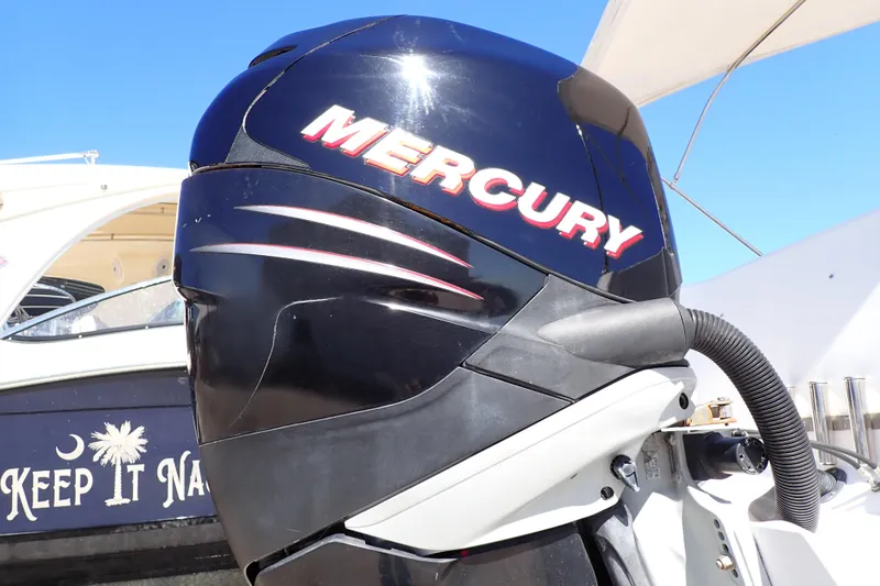 Slide: The Image of Mercury outboard motor on a 2014 Pro-Line 32 Express boat under clear blue sky. - 107