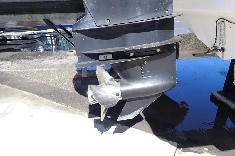 Slide: The Image of 2014 Pro-Line 32 Express boat propeller and lower unit on a wet dock. - 109
