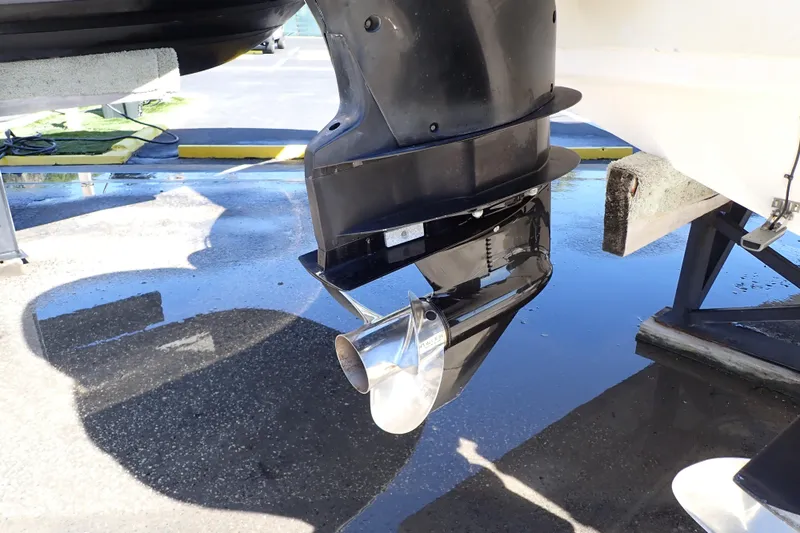 Slide: The Image of 2014 Pro-Line 32 Express boat propeller and outboard motor close-up. - 115