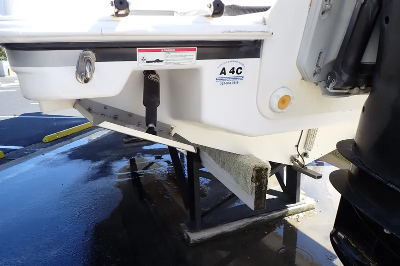 Slide: The Image of 2014 Pro-Line 32 Express boat stern view with trim tabs and outboard motor. - 119