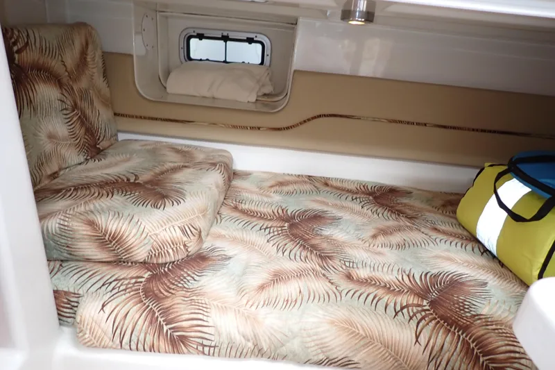 Slide: The Image of Cozy cabin interior of 2014 Pro-Line 32 Express with tropical-patterned bedding. - 12