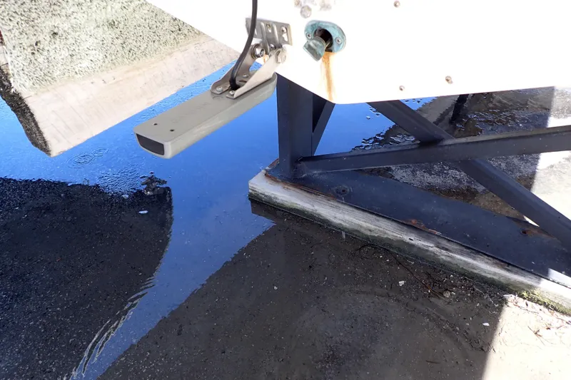 Slide: The Image of 2014 Pro-Line 32 Express boat hull on a stand with water puddle. - 121
