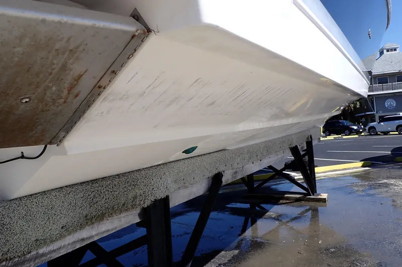 Slide: The Image of 2014 Pro-Line 32 Express boat hull on dry dock, showing underside and support structure. - 122