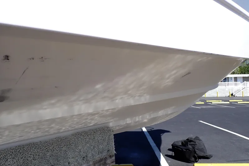 Slide: The Image of 2014 Pro-Line 32 Express boat hull on trailer in parking lot. - 124