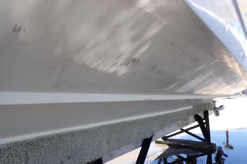 Slide: The Image of 2014 Pro-Line 32 Express boat hull on dry dock, showing underside details. - 128