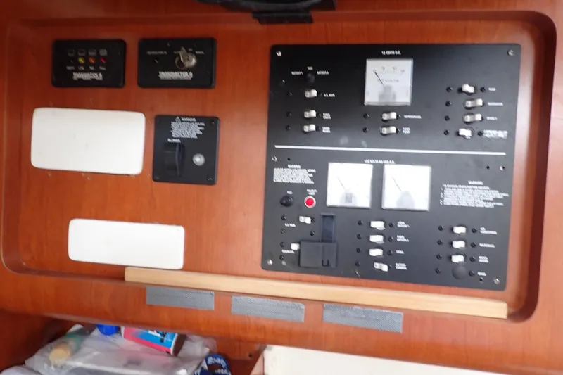 Slide: The Image of Control panel of a 2014 Pro-Line 32 Express boat with switches and gauges. - 14