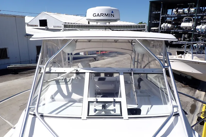 Slide: The Image of 2014 Pro-Line 32 Express boat with Garmin radar, docked at a marina. - 18