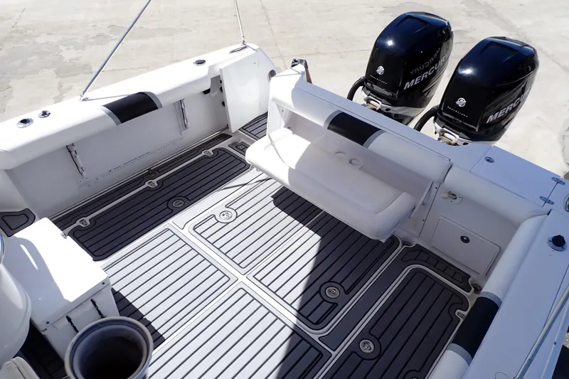 Slide: The Image of 2014 Pro-Line 32 Express boat deck with twin Mercury engines. - 19