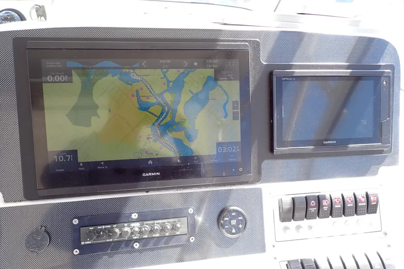 Slide: The Image of Dashboard of 2014 Pro-Line 32 Express with Garmin navigation displays. - 22
