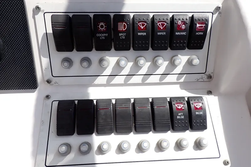 Slide: The Image of Control panel of a 2014 Pro-Line 32 Express boat with labeled switches. - 24