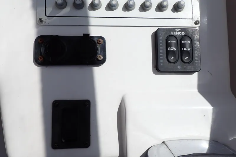 Slide: The Image of Control panel of a 2014 Pro-Line 32 Express boat with Lenco trim tab switches. - 25