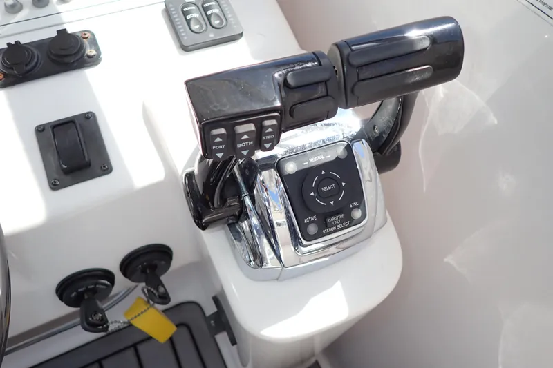Slide: The Image of Close-up of 2014 Pro-Line 32 Express boat throttle controls and dashboard. - 26