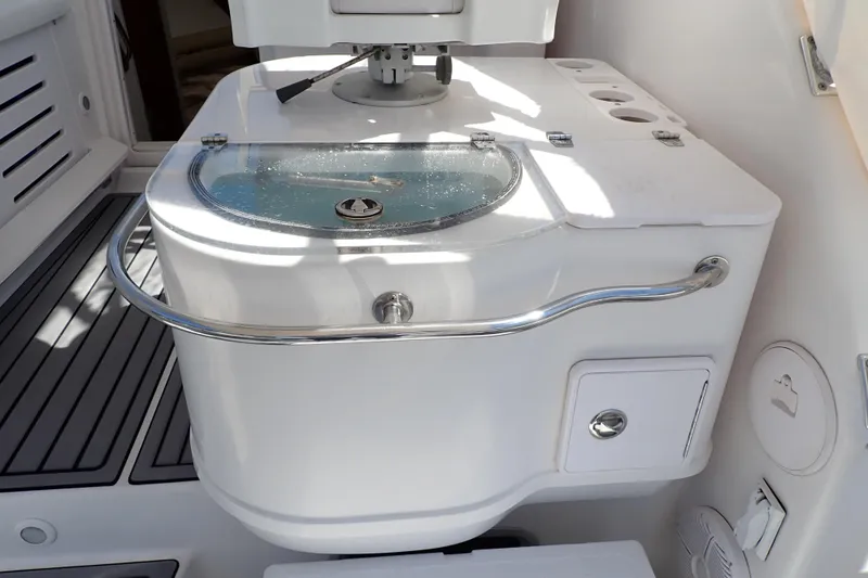 Slide: The Image of Livewell on 2014 Pro-Line 32 Express boat, featuring stainless steel rail and storage compartment. - 29