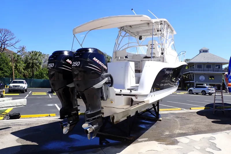 Slide: The Image of 2014 Pro-Line 32 Express boat with twin Mercury 250 engines on a trailer. - 3
