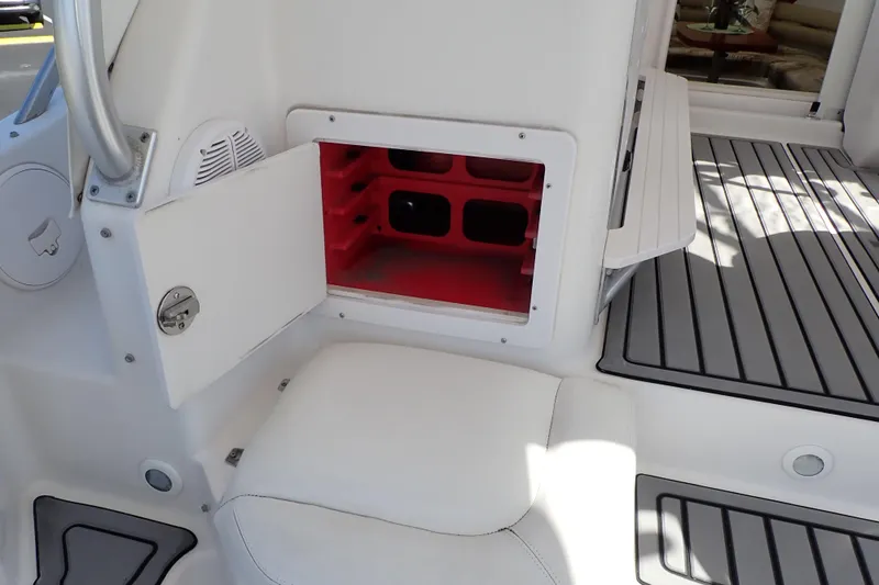 Slide: The Image of 2014 Pro-Line 32 Express boat interior with open storage compartment and seating. - 34