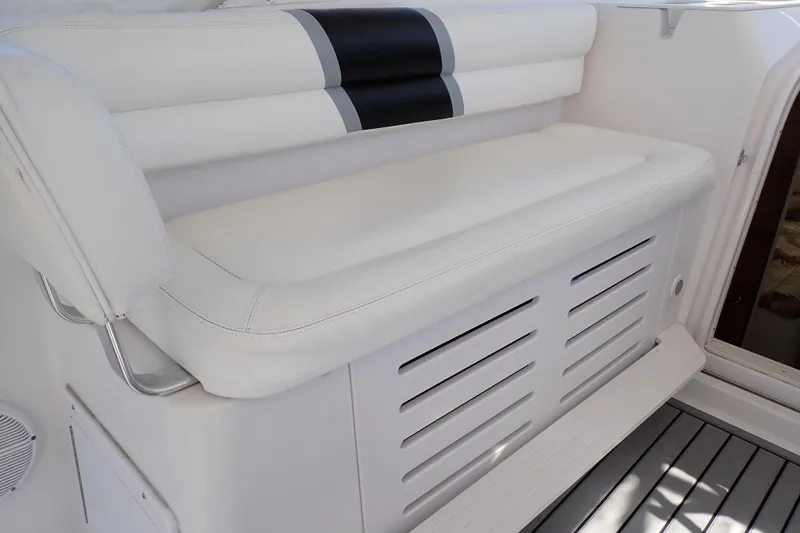 Slide: The Image of White cushioned seating on 2014 Pro-Line 32 Express boat, featuring sleek design and storage. - 35