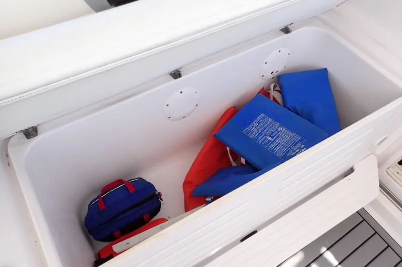 Slide: The Image of Storage compartment on 2014 Pro-Line 32 Express boat with life jackets and gear. - 36