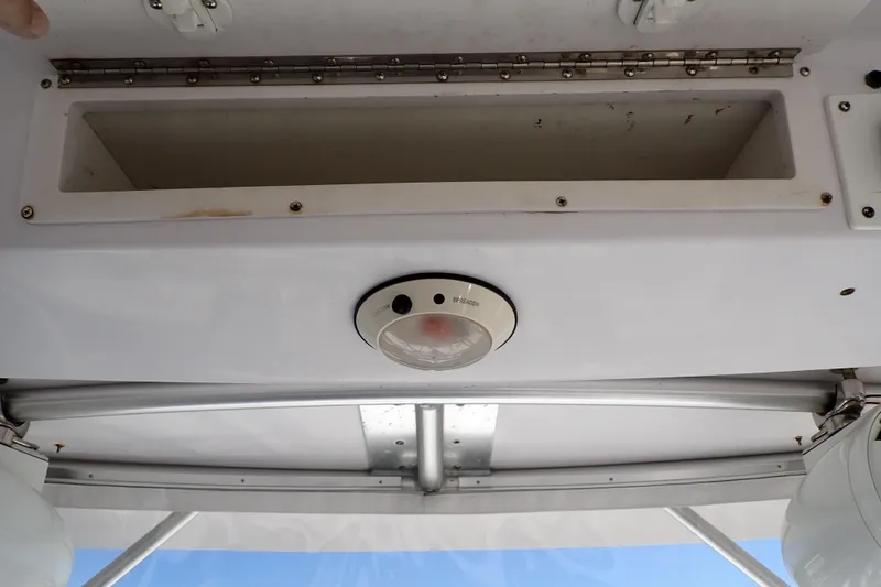 Slide: The Image of 2014 Pro-Line 32 Express boat interior with storage compartment and ceiling light. - 40