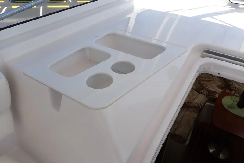 Slide: The Image of Interior view of a 2014 Pro-Line 32 Express boat with cup holders and seating area. - 42