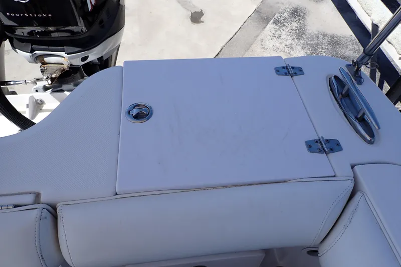 Slide: The Image of 2014 Pro-Line 32 Express boat deck with storage compartment and outboard motor. - 43