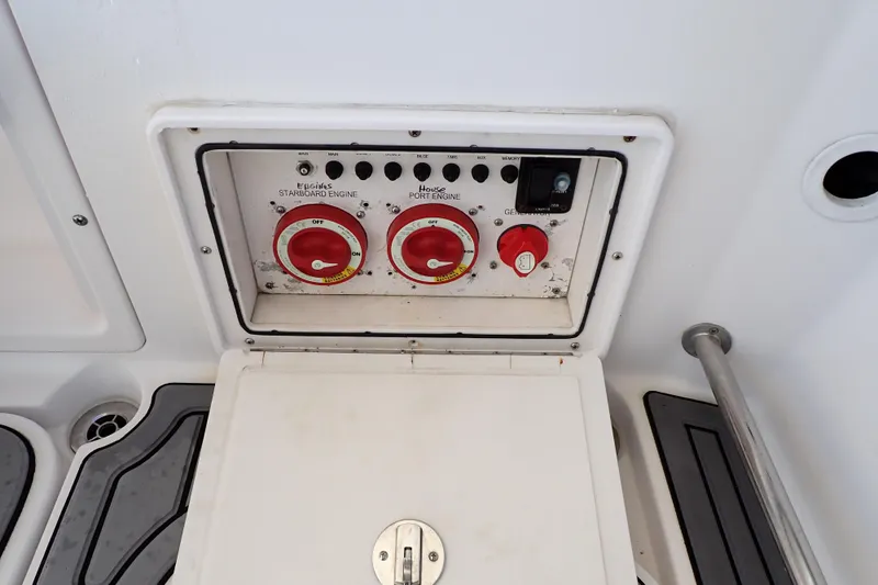 Slide: The Image of Control panel of a 2014 Pro-Line 32 Express boat, featuring engine switches. - 46