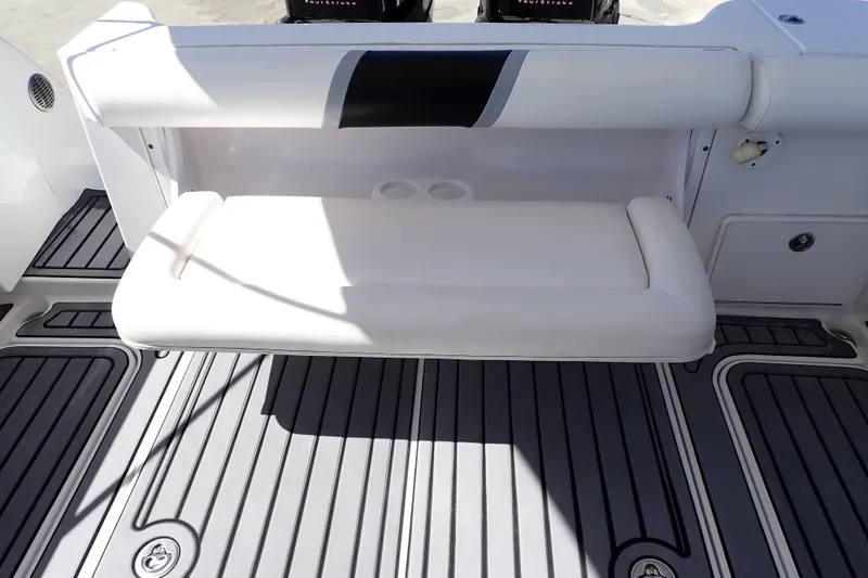 Slide: The Image of 2014 Pro-Line 32 Express boat interior with cushioned seating and sleek flooring. - 47