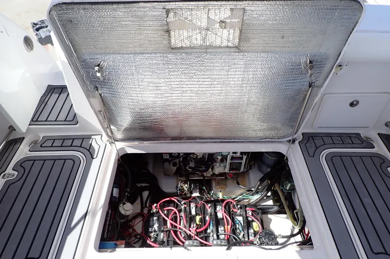 Slide: The Image of Open engine compartment of 2014 Pro-Line 32 Express boat, showcasing wiring and components. - 52