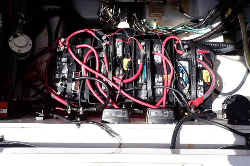 Slide: The Image of Battery compartment of 2014 Pro-Line 32 Express boat with red cables and wiring. - 53