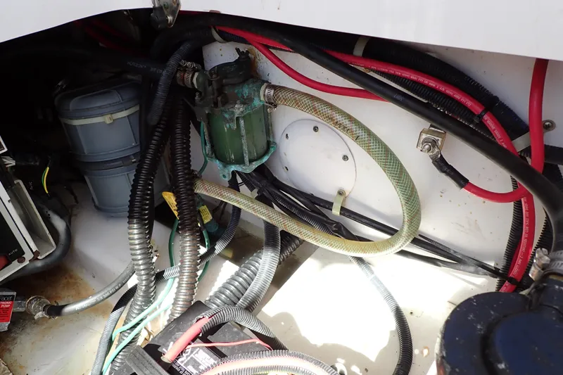 Slide: The Image of Engine compartment of a 2014 Pro-Line 32 Express boat with visible wiring and hoses. - 55