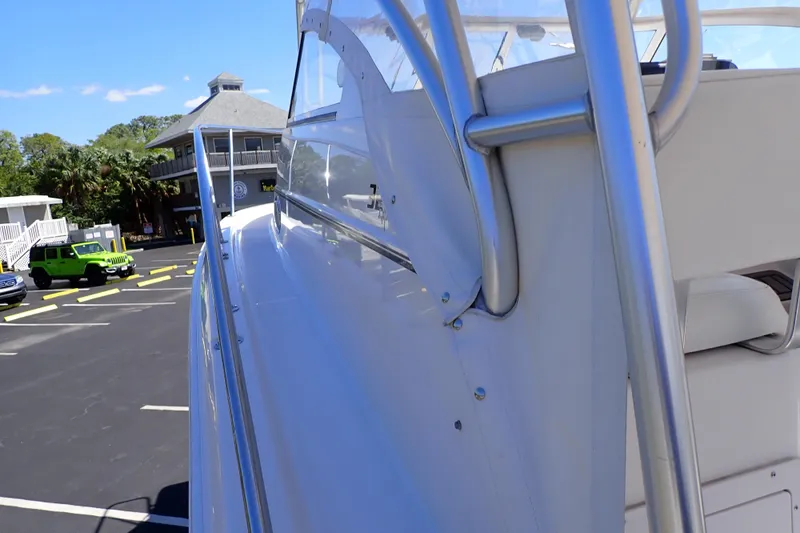 Slide: The Image of 2014 Pro-Line 32 Express boat parked near a marina with clear blue skies. - 68