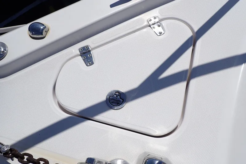 Slide: The Image of Hatch on 2014 Pro-Line 32 Express boat deck with metal fixtures and shadows. - 69