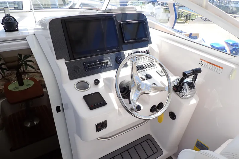 Slide: The Image of Cockpit of 2014 Pro-Line 32 Express boat with steering wheel and control panel. - 7